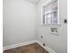 Small laundry room with wood-look flooring at 747 Bethesda School Rd, Lawrenceville, GA 30044