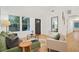 Living room featuring hardwood floors, a green couch, and natural light from windows at 1675 Avon Sw Ave, Atlanta, GA 30311