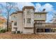 Two-story house back with beige siding, deck, and wooded area at 3455 Lake Seminole Dr, Buford, GA 30519