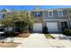 Two-story townhome with gray siding, brick accents, and a two-car garage at 1510 Vernon Blvd, Decatur, GA 30035