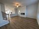 Inviting living room with a fireplace, ceiling fan, and wood-look flooring at 165 Wallace St, Fayetteville, GA 30214