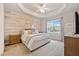 Main bedroom with wood-look accent wall, plush carpet, and neutral decor at 224 Orchards Cir, Woodstock, GA 30188