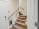 Carpeted staircase with a wooden handrail at 2482 Crescent Park Ct, Atlanta, GA 30339