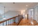 Upstairs hallway with hardwood floors and wood railing at 3365 Preservation Cir, Lilburn, GA 30047