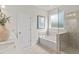 Bathroom with soaking tub, walk-in shower, and tile flooring at 545 Nolden Trl, Dacula, GA 30019