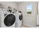 Laundry room with washer, dryer, and shelving at 545 Nolden Trl, Dacula, GA 30019