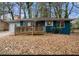 Ranch home with blue exterior, wood ramp, and mature trees at 1089 Indale Sw Pl, Atlanta, GA 30310