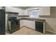 Kitchen with white cabinets, black appliances, and tile floors at 1962 Pine Oak Sw Dr, Atlanta, GA 30310