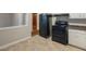 Galley kitchen with black appliances and tile floor at 1962 Pine Oak Sw Dr, Atlanta, GA 30310