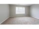 Simple bedroom with carpet flooring and large window at 1215 Catalina Pkwy, Mcdonough, GA 30252