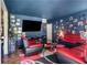 Living room with red couches and a large TV at 1279 Kenilworth Sw Dr, Atlanta, GA 30310