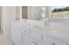 Double vanity bathroom with white cabinets and quartz countertops at 514 Nolden Trl, Dacula, GA 30019