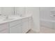 Double vanity bathroom with white cabinets and a shower/tub combo at 514 Nolden Trl, Dacula, GA 30019