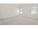 Spacious bedroom with carpet and two large windows at 514 Nolden Trl, Dacula, GA 30019