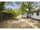 Backyard view with a wooden fence and overgrown vegetation at 1321 Mcclelland Ave, Atlanta, GA 30344