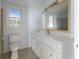 Clean bathroom, featuring a vanity with white cabinets and a large mirror at 1321 Mcclelland Ave, Atlanta, GA 30344