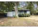 View of the home's side and backyard, showing a tree and fence at 1321 Mcclelland Ave, Atlanta, GA 30344