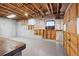 Unfinished basement area with concrete floor, exposed insulation, and garage door access at 2447 Lakeshore Ne Dr, Conyers, GA 30012