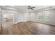 Open plan basement space with wood floors, ceiling fan, and view of kitchen at 4745 Gablestone Xing, Hoschton, GA 30548