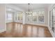 Bright dining room with ample natural light, hardwood flooring, and a chandelier at 4745 Gablestone Xing, Hoschton, GA 30548