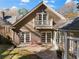 Exterior view of home and back patio with a balcony and landscaping at 495 Claire Ne Dr, Atlanta, GA 30307