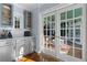 French doors open to a sunroom from updated kitchen and bar area at 495 Claire Ne Dr, Atlanta, GA 30307