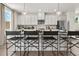 Kitchen island with seating and modern pendant lighting at 315 Sammon Way, Lawrenceville, GA 30046