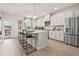 Modern kitchen with island, stainless steel appliances, and white cabinets at 315 Sammon Way, Lawrenceville, GA 30046