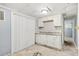 Small basement kitchen with white cabinets and subway tile backsplash at 3530 Fairlane Nw Dr, Atlanta, GA 30331