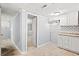 Unfinished basement kitchen with white cabinets and subway tile backsplash at 3530 Fairlane Nw Dr, Atlanta, GA 30331