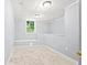 Unfinished basement room with window and built-in bench at 3530 Fairlane Nw Dr, Atlanta, GA 30331