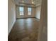 Spacious bedroom with hardwood floors and two large windows at 500 Chiswick Cir, Alpharetta, GA 30009