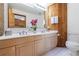 Bathroom with double vanity and wood-paneled walls at 1379 The By Ne Way, Atlanta, GA 30306