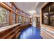 Sunroom with blue tile floors, wooden shelves, and wall of windows at 1379 The By Ne Way, Atlanta, GA 30306