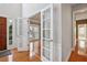 Bright entryway with French doors leading to a living area with hardwood floors at 185 Witheridge Dr, Johns Creek, GA 30097