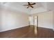 Large, bright main bedroom with wood floors, a ceiling fan, and tray ceiling at 185 Witheridge Dr, Johns Creek, GA 30097