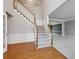 Elegant staircase with carpeted steps and hardwood flooring at 185 Witheridge Dr, Johns Creek, GA 30097