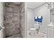 Bathroom with a shower, toilet and gray marble-style tile at 1324 Almont Sw Dr, Atlanta, GA 30310