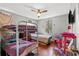 Bedroom with bunk beds, hardwood floors, and a ceiling fan at 1324 Almont Sw Dr, Atlanta, GA 30310