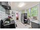 Kitchen with gray cabinets, tile backsplash, and modern appliances at 1324 Almont Sw Dr, Atlanta, GA 30310