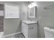 Modern bathroom with white vanity, granite countertop, and gray tile at 1544 Childress Sw Dr, Atlanta, GA 30311