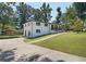 Newly renovated ranch house with carport, spacious lawn, and inviting front entrance at 2595 Creekview Sw Dr, Marietta, GA 30008