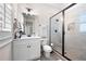 Modern bathroom with white vanity, glass shower, and neutral tile at 304 Woodstock Seven Dr, Woodstock, GA 30188