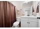 Clean bathroom with shower/tub combo, toilet, and vanity with white cabinets at 304 Woodstock Seven Dr, Woodstock, GA 30188