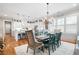 Open concept dining room adjacent to kitchen, featuring hardwood floors and a large farmhouse table at 304 Woodstock Seven Dr, Woodstock, GA 30188