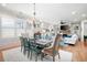 Bright dining room with a farmhouse table, chandelier, and view into the living room at 304 Woodstock Seven Dr, Woodstock, GA 30188