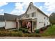 Charming two-story home with brick accents and a covered porch at 304 Woodstock Seven Dr, Woodstock, GA 30188