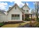 Two-story home with white siding, brick accents, and American flag at 304 Woodstock Seven Dr, Woodstock, GA 30188