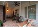 Covered porch with brick floor, ceiling fan, and swing at 304 Woodstock Seven Dr, Woodstock, GA 30188