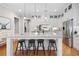 Open concept kitchen with white cabinets, granite island and pendant lighting at 304 Woodstock Seven Dr, Woodstock, GA 30188